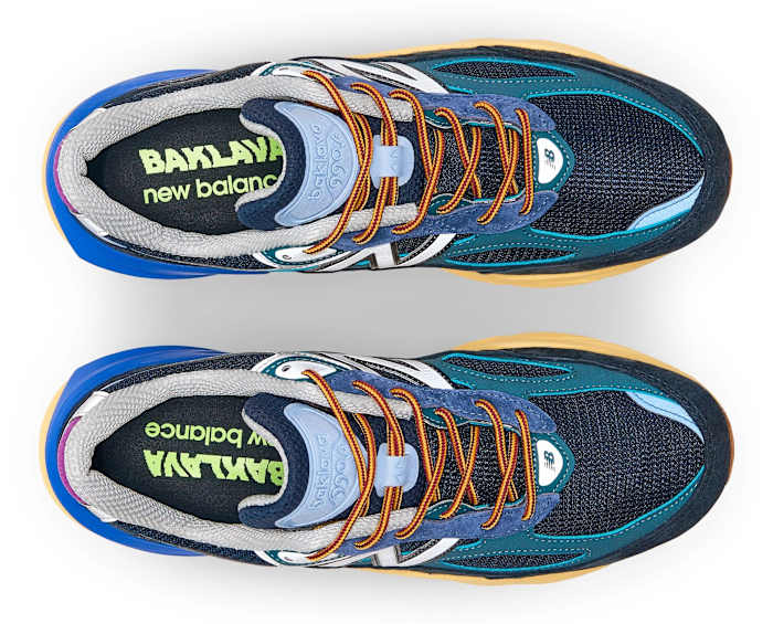 View of blue and orange New Balance shoes.